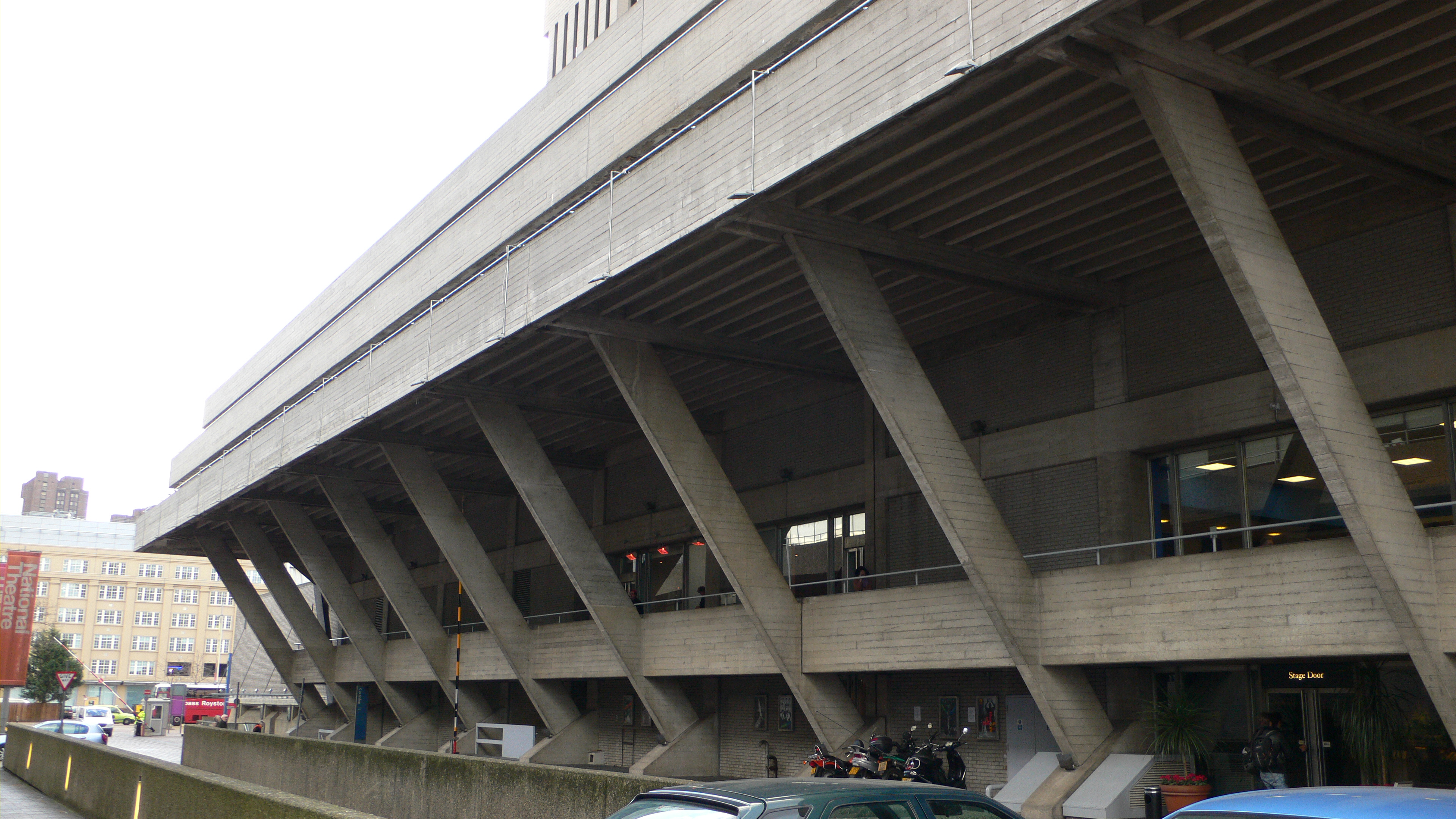 Repeated exposed concrete supports and deep shadows on the east side of London’s National Theatre.